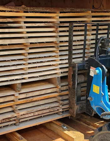 Loading cut lumber into kiln.Sawmill cutting large white oak