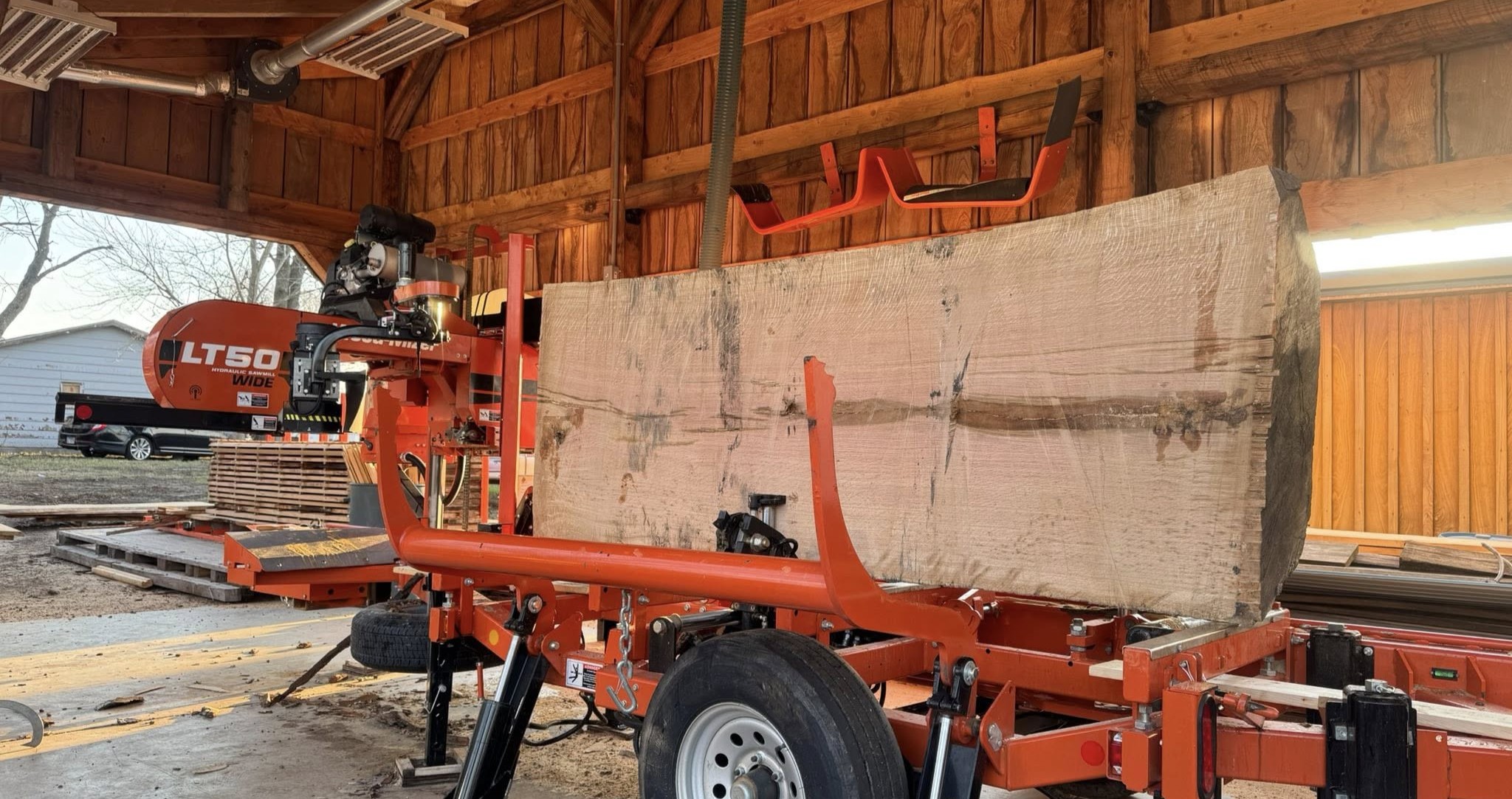 Diller Millworks large white oak log partially cut on the mill